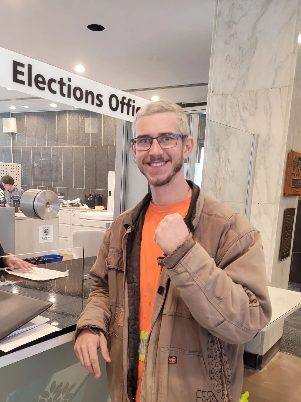 Zack Ramsey, in his work jacket, filing his nomination papers at the London Elections Office